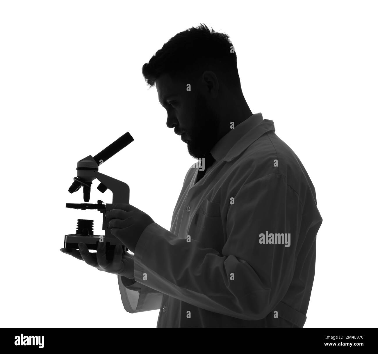 Silhouette of male scientist with microscope on white background Stock Photo