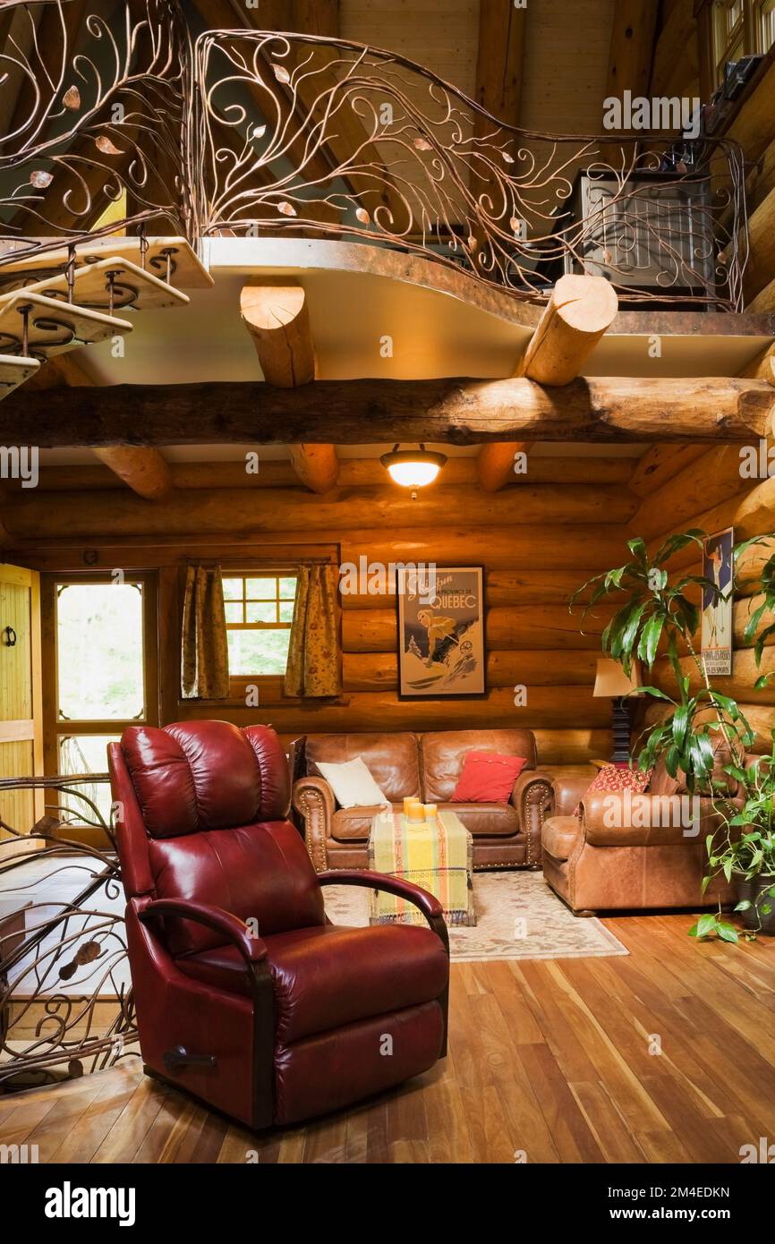 Spiral shaped wood and wrought iron staircase railing and red leather