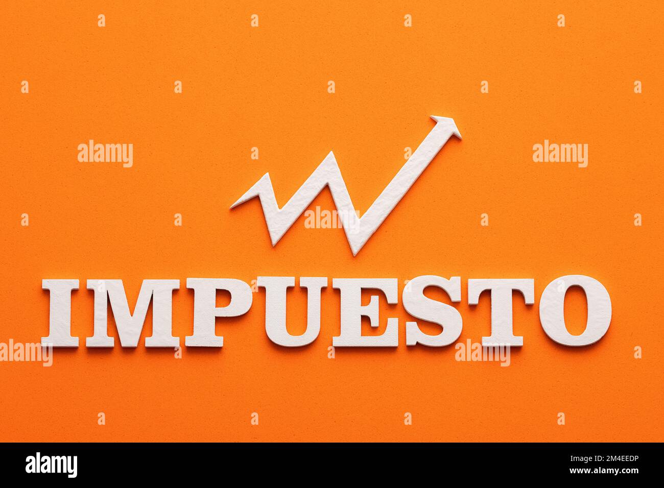 The tax is increased In white letters the word tax in spanish language Stock Photo Alamy