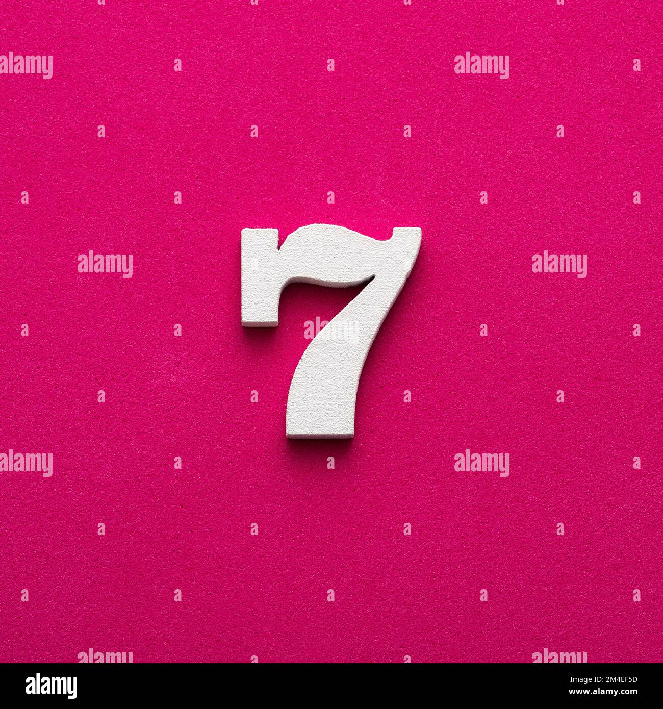 Number seven - white number in wood on rhodamine red background Stock ...