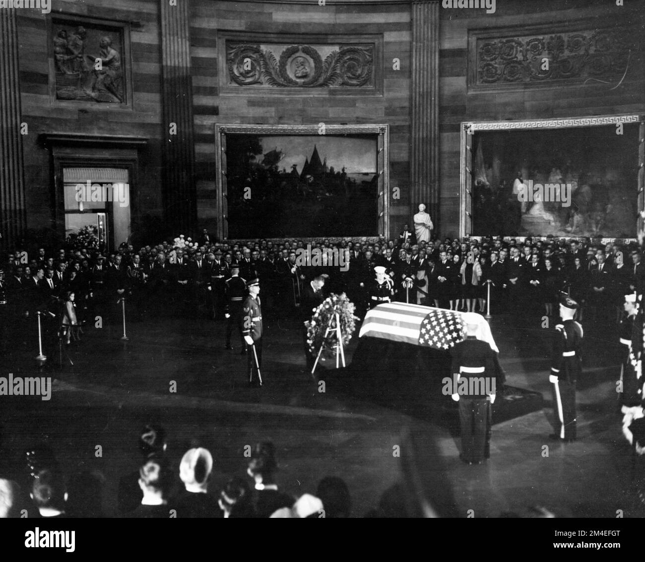 President Lyndon B. Johnson placing a wreath before the flag-draped casket of President Kennedy, during funeral services held in the United States Capitol Rotunda, November 24, 1963. Stock Photo