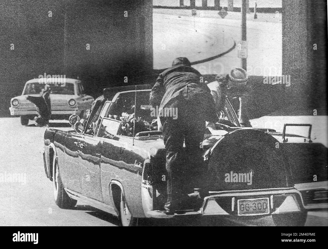 Agent Hill climbs aboard the presidential limousine to protect the occupants in the seconds after the assassination of presidet John F Kennedy Stock Photo