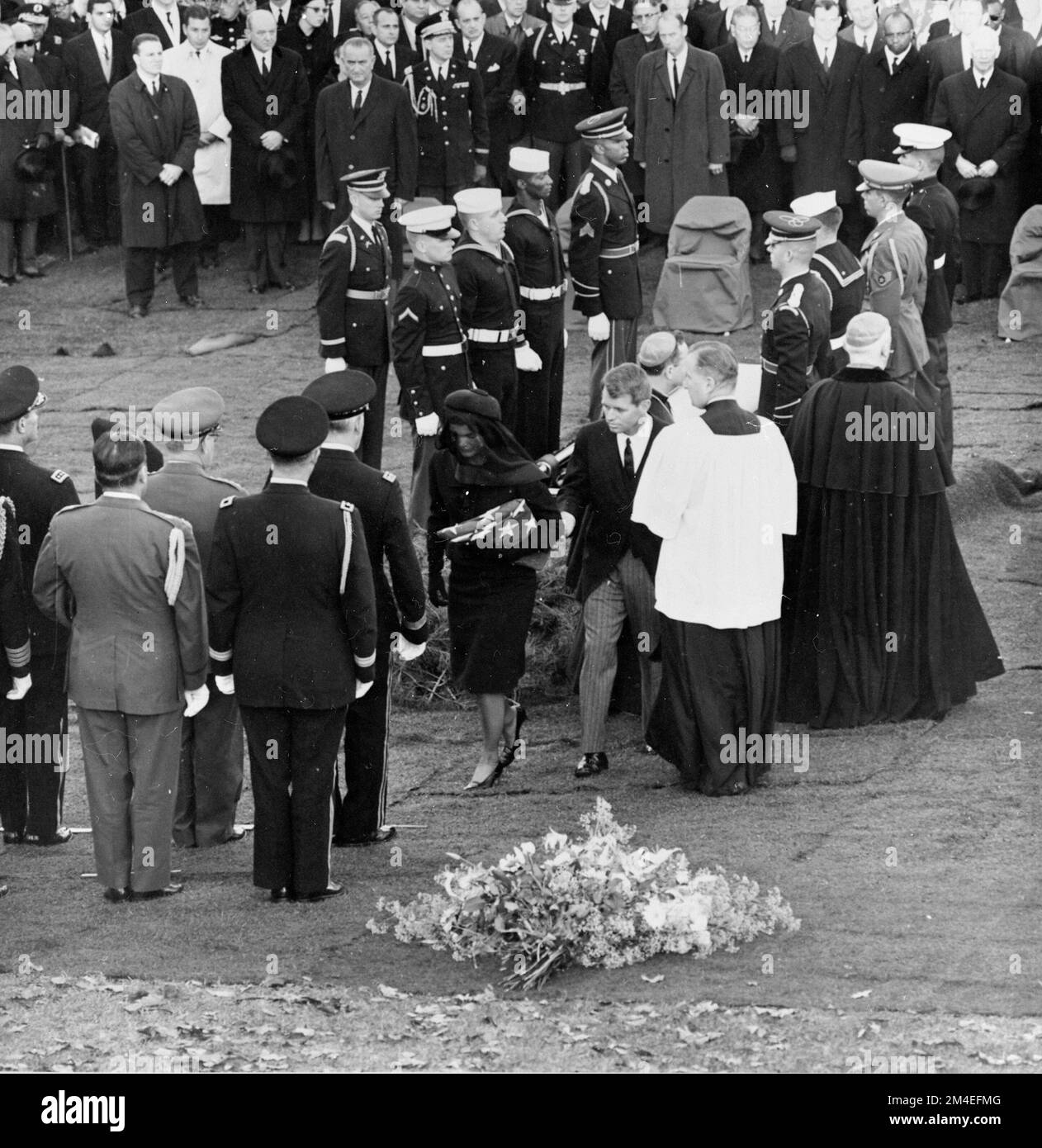 Jacqueline Kennedy and Attorney General Robert F. Kennedy walk away from President Kennedy's casket during interment at Arlington National Cemetery on November 25, 1963. Stock Photo