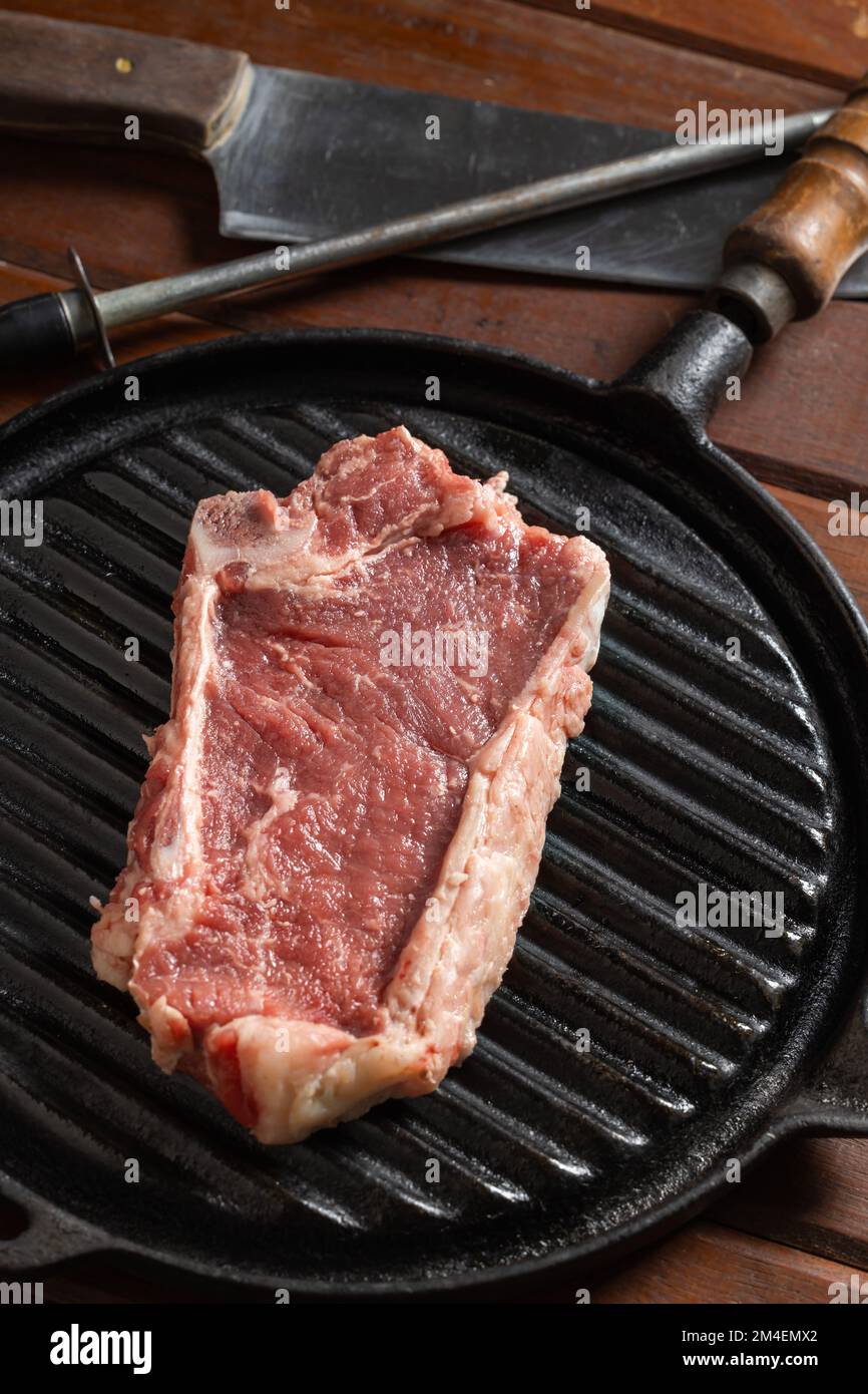 Raw Argentine steak on a griddle. Stock Photo
