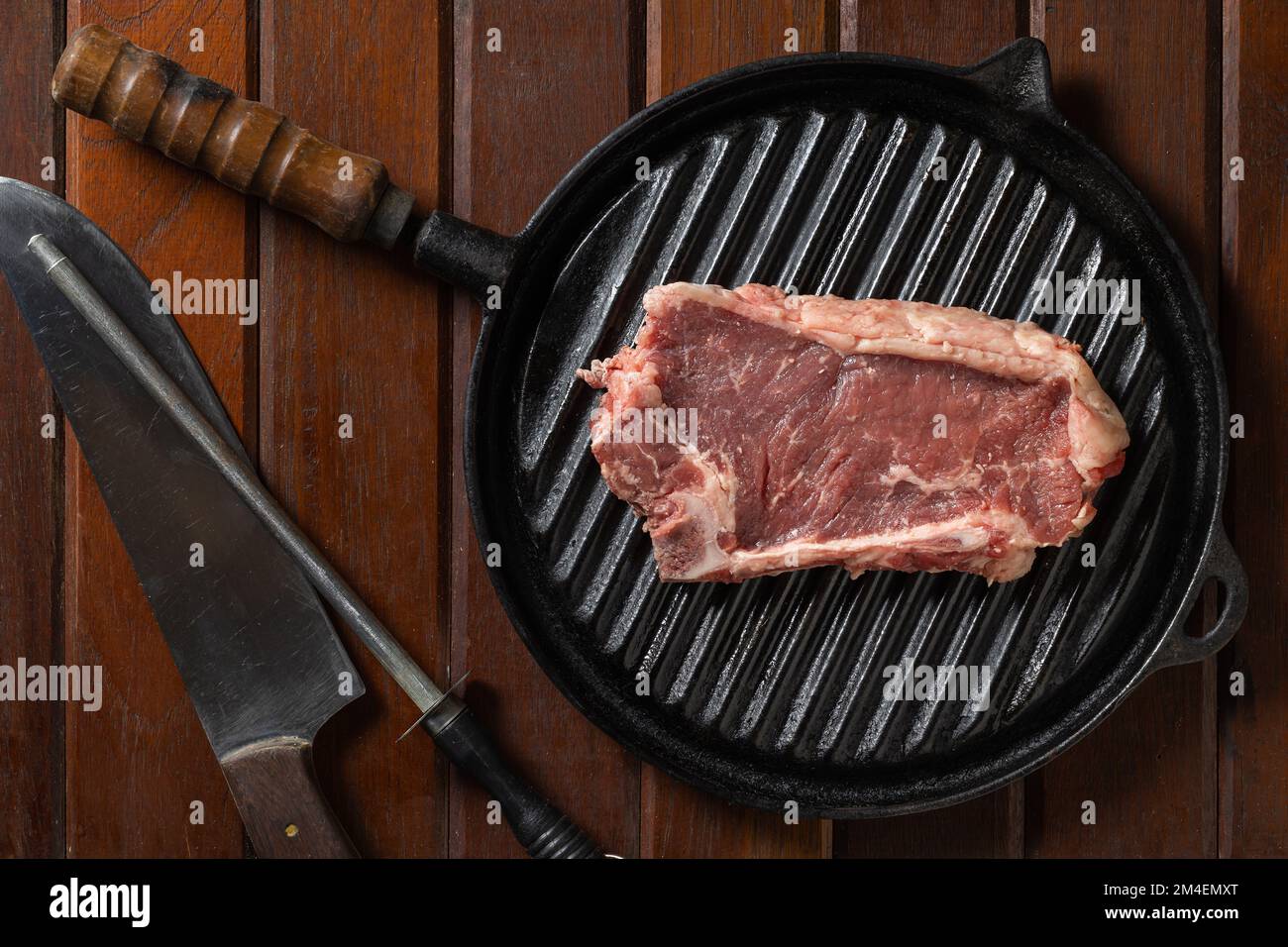 Top view of raw Argentine steak on a griddle. Stock Photo