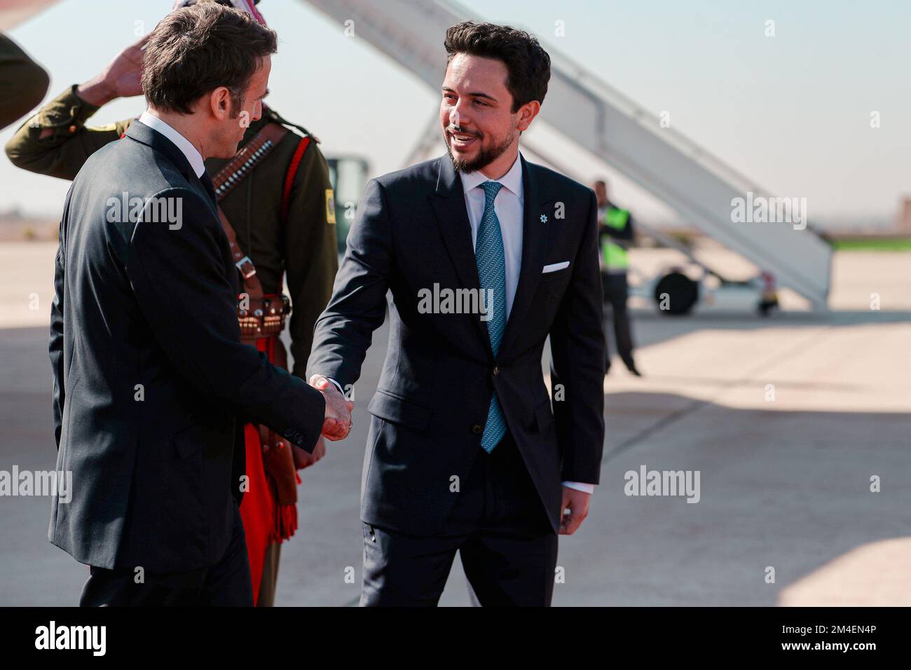 Amman, Jordan. 20th Dec, 2022. France's President Emmanuel Macron (L) is welcomed by the Crown Prince of Jordan Hussein bin Abdullah (R) at Queen Alia International Airport in Amman as he arrives to attend the second Baghdad conference for Cooperation and Partnership in Sweimeh by the Dead Sea shore in central-west Jordan on December 20, 2022. Photo by Royal Hashemite Court/UPI Credit: UPI/Alamy Live News Stock Photo