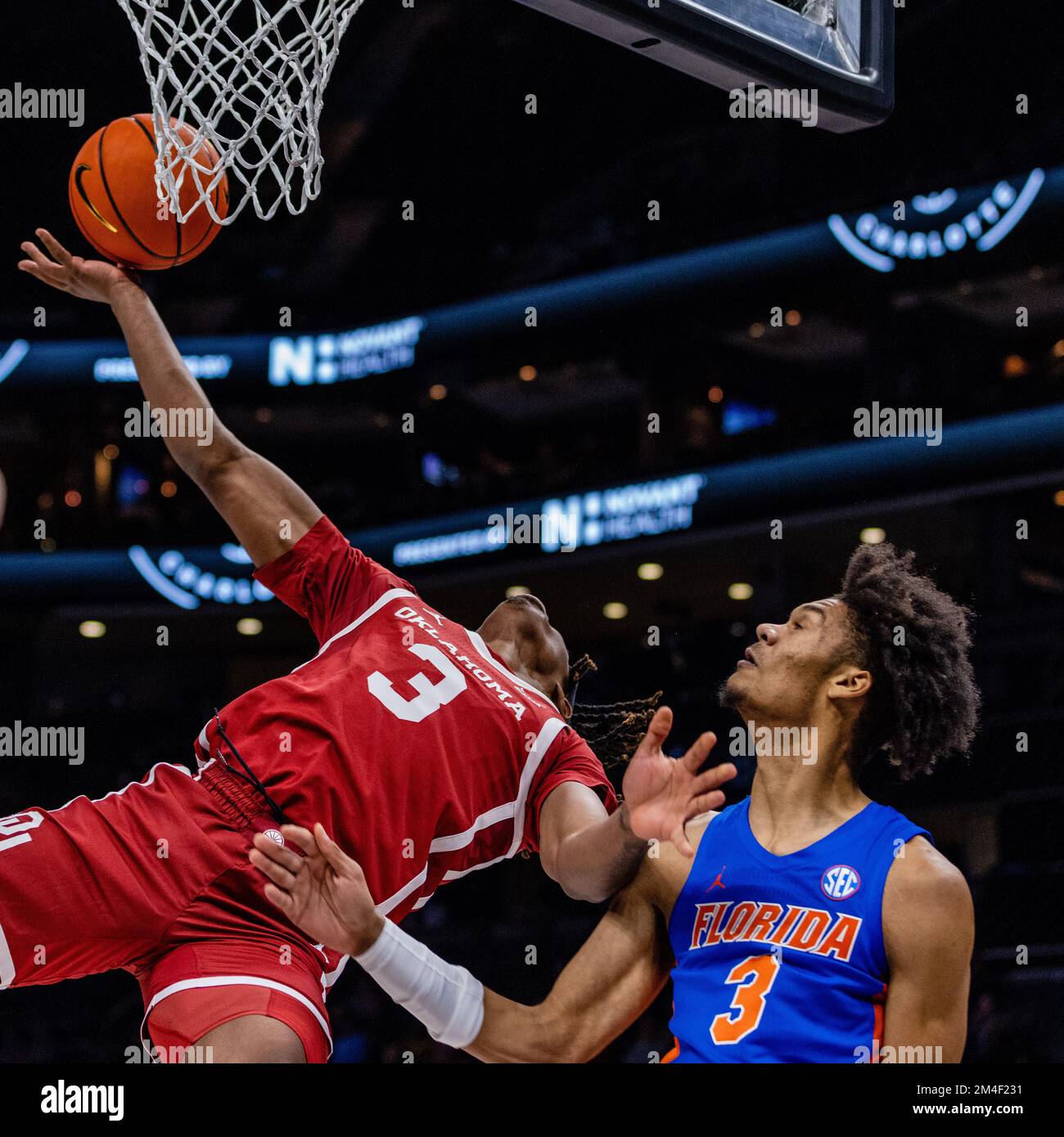 Charlotte, NC, USA. 20th Dec, 2022. Oklahoma Sooners guard Otega Oweh (3) is fouled as he shoots by Florida Gators forward Alex Fudge (3) during the first half of the 2022 Jumpman Invitational at Spectrum Center in Charlotte, NC. (Scott Kinser/CSM). Credit: csm/Alamy Live News Stock Photo