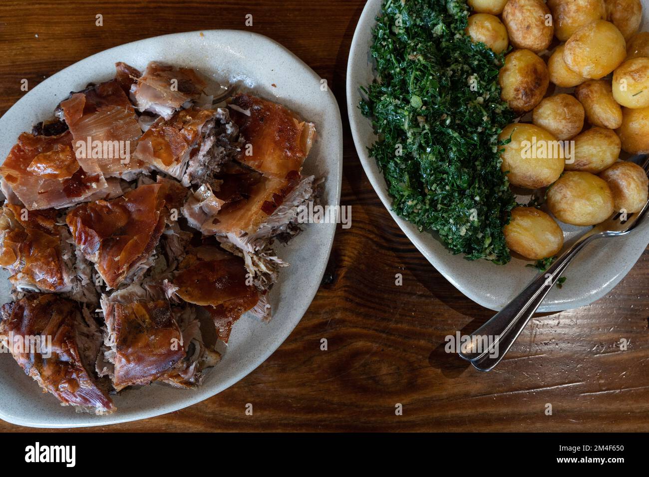 Cabrito estonado portuguese oven rosted goatling dish from the region of Oleiros, Portugal, Europe with a side dish of roasted potatoes and cabbage Stock Photo