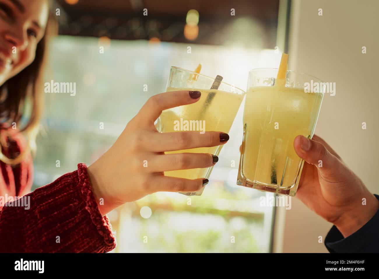 Cheers to us. a young couple toasting with their drinks at a coffee