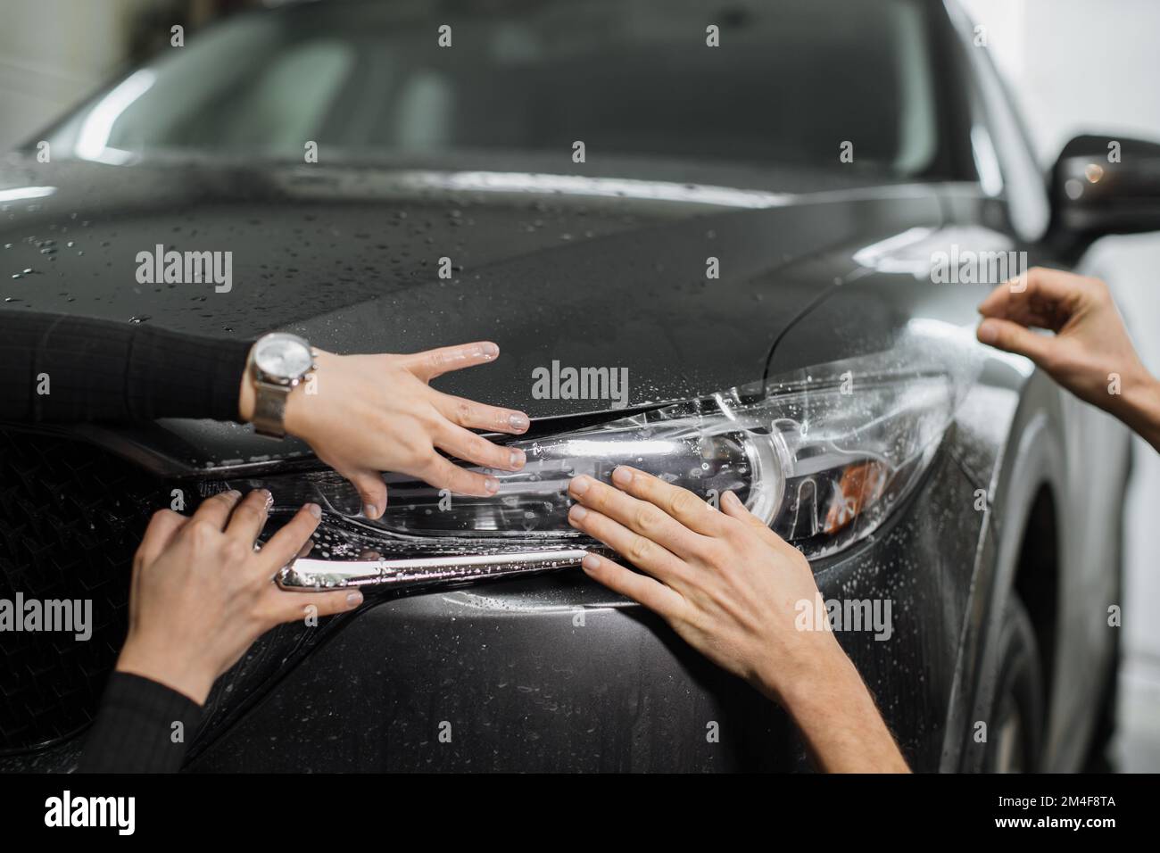 Close up to PPF installation process on a front headlight . PPF is a