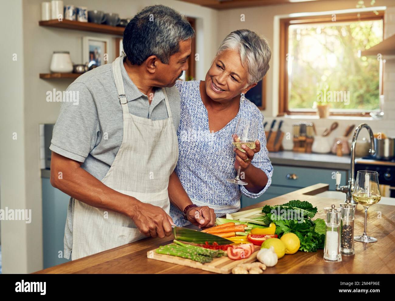 Nothing says love like a home cooked meal. a happy mature couple cooking a meal together at home. Stock Photo