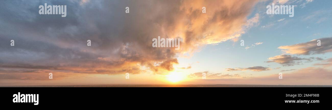 Panorama of dramatic sunset sky with fluffy clouds Stock Photo - Alamy