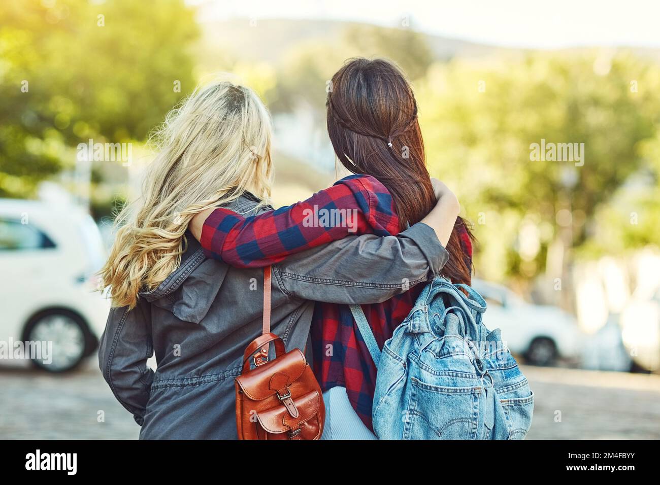 I wouldnt travel without my bestie. Rearview shot of two unrecognizable female friends sight seeing in the city. Stock Photo
