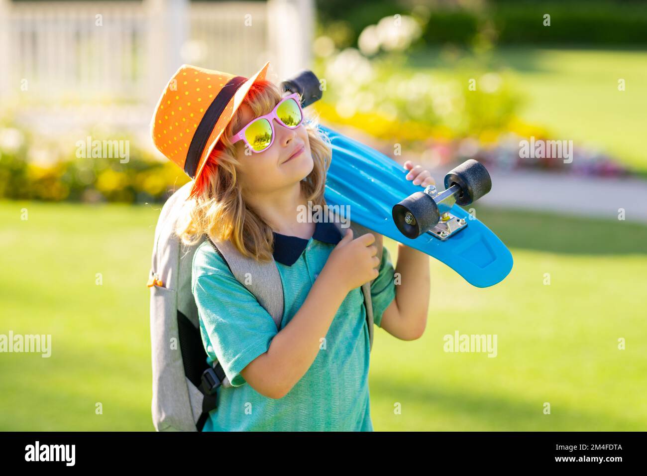 Summer kids fashion. Kid with skateboard. Child hold skate board