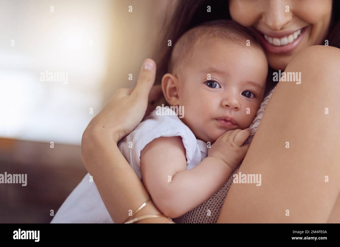 Moms arms, the safest place on earth. a young woman bonding with her baby boy at home. Stock Photo