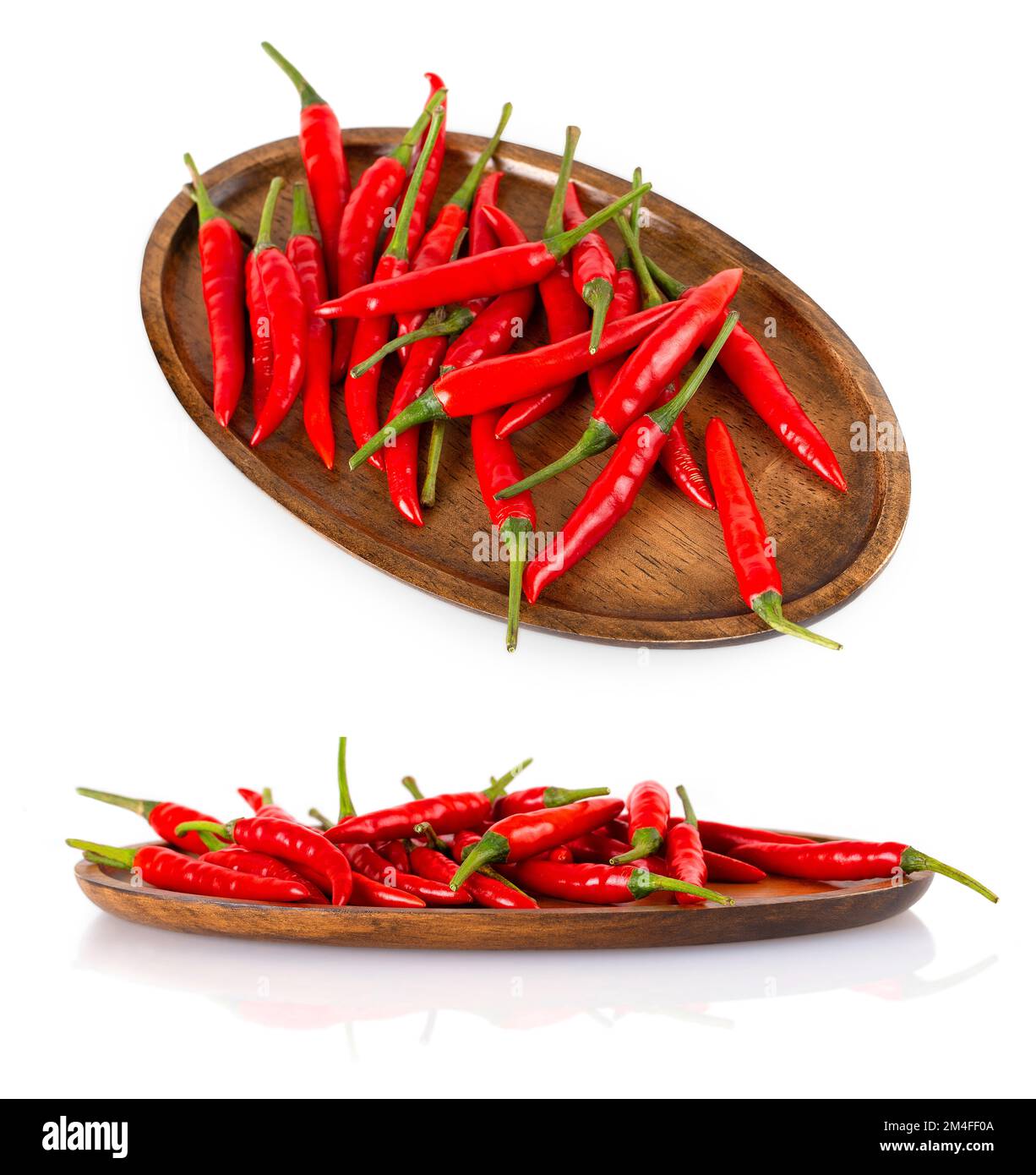 The Red hot chili peppers on a wooden plate isolated on white ...