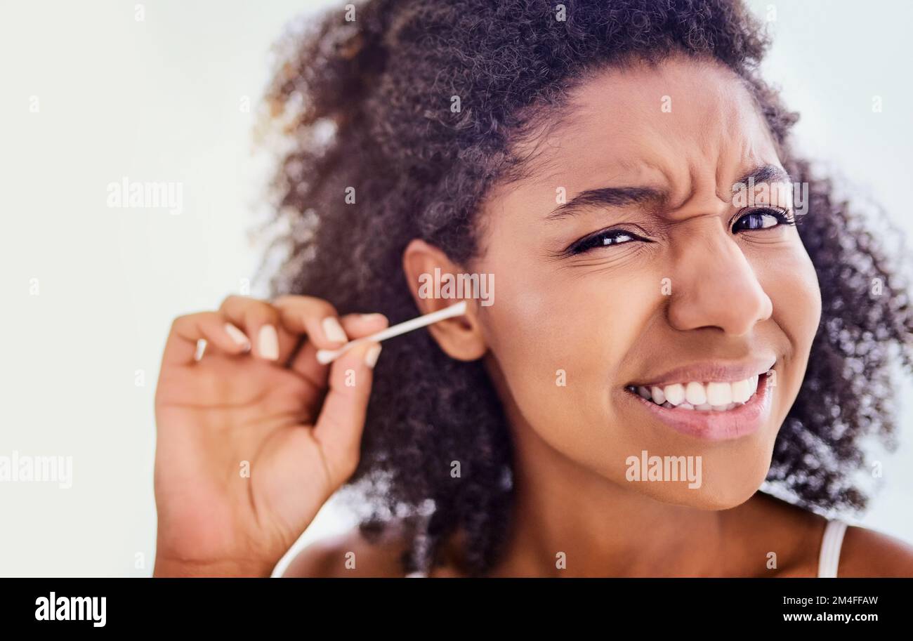 Delving into the ear canal. an attractive young woman cleaning her ears