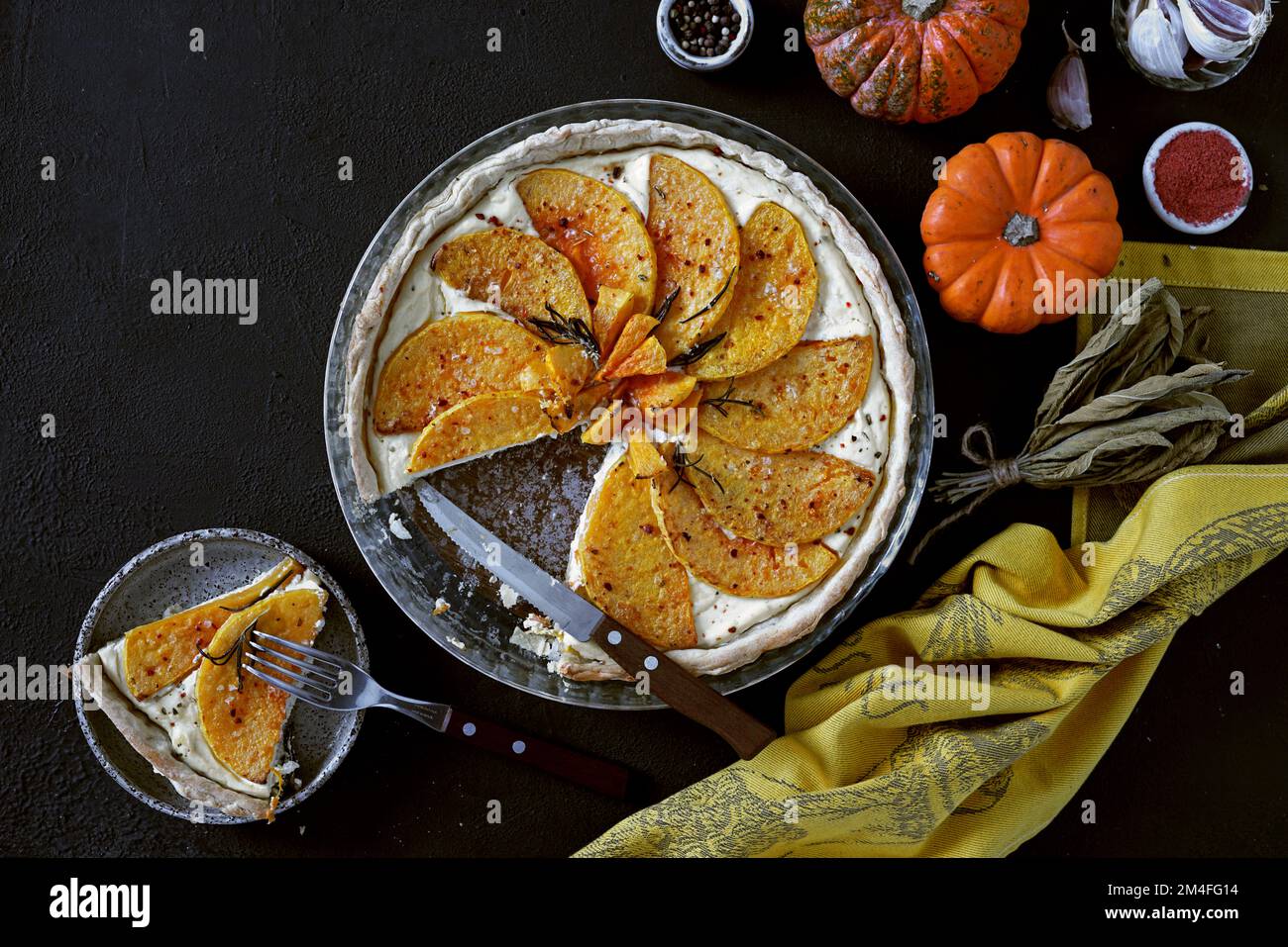 Pumpkin tart with cheese and spice on dark background, top view, copy space Stock Photo