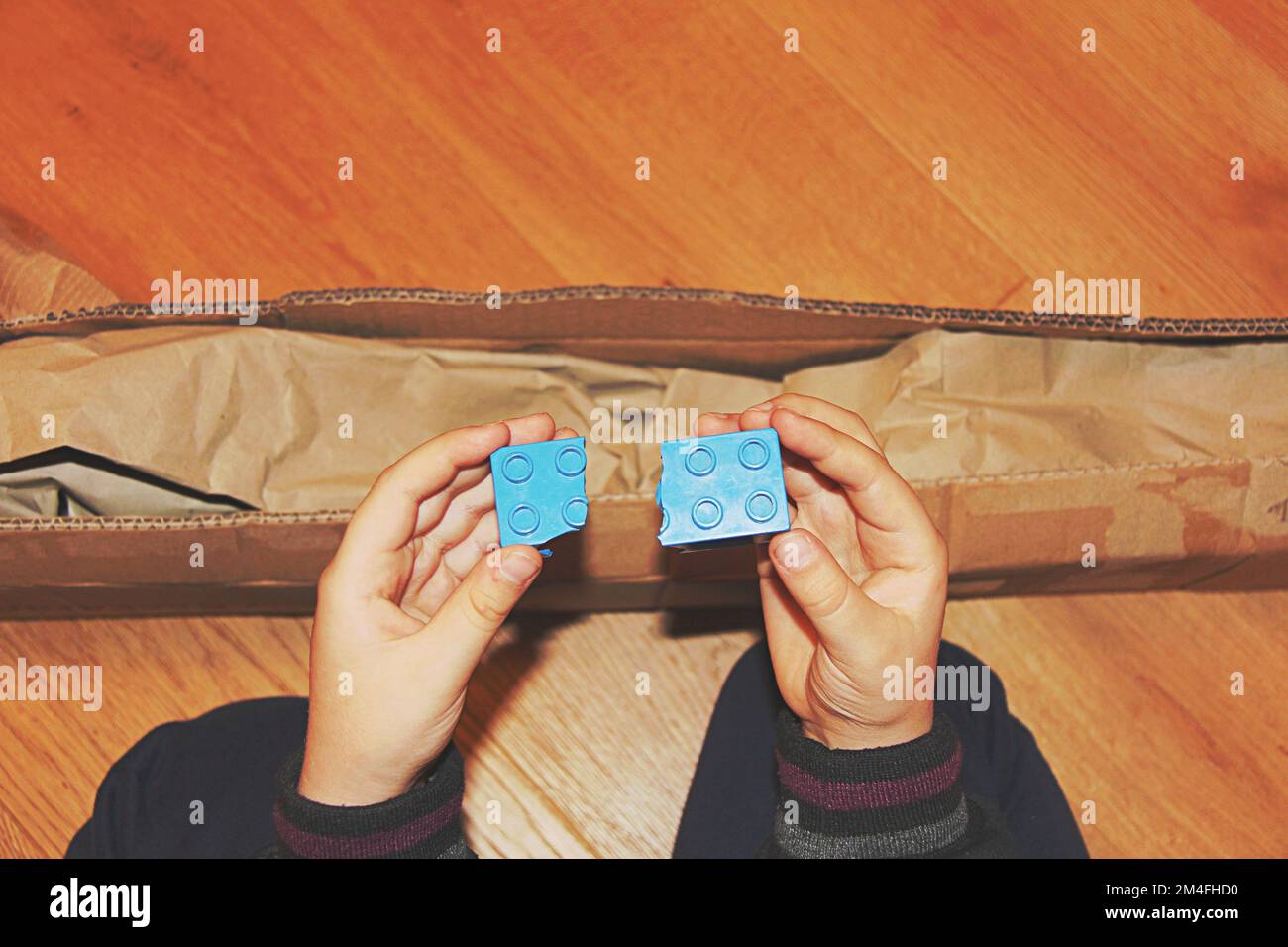 Broken toy in damaged cardboard box top view, damaged home delivery