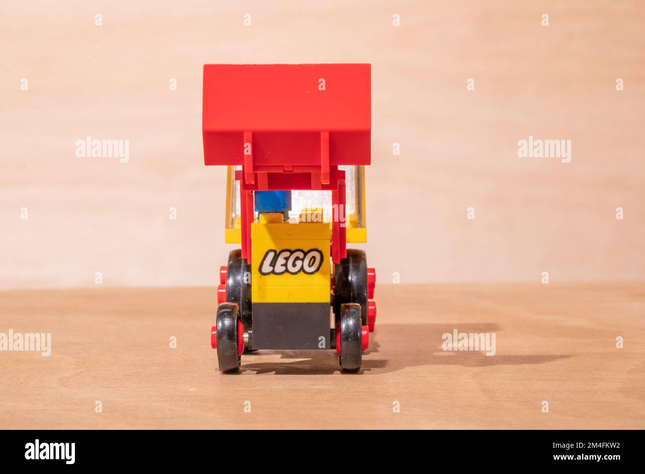 A closeup shot of a vintage Lego model of an excavator placed on a ...