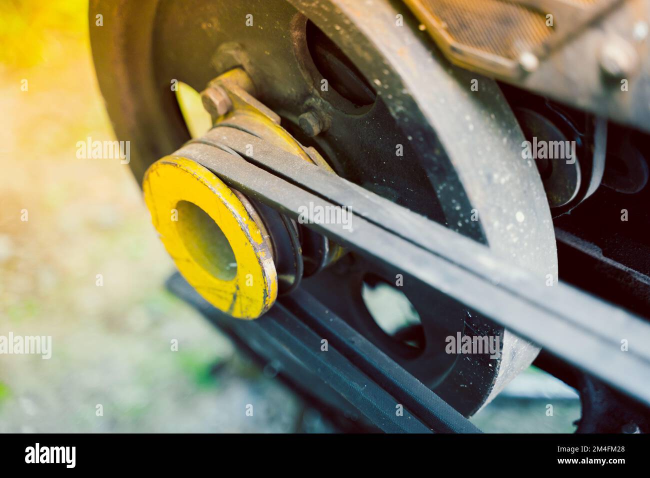 Walkbehind tractor pulley with two belts closeup. Tractor for