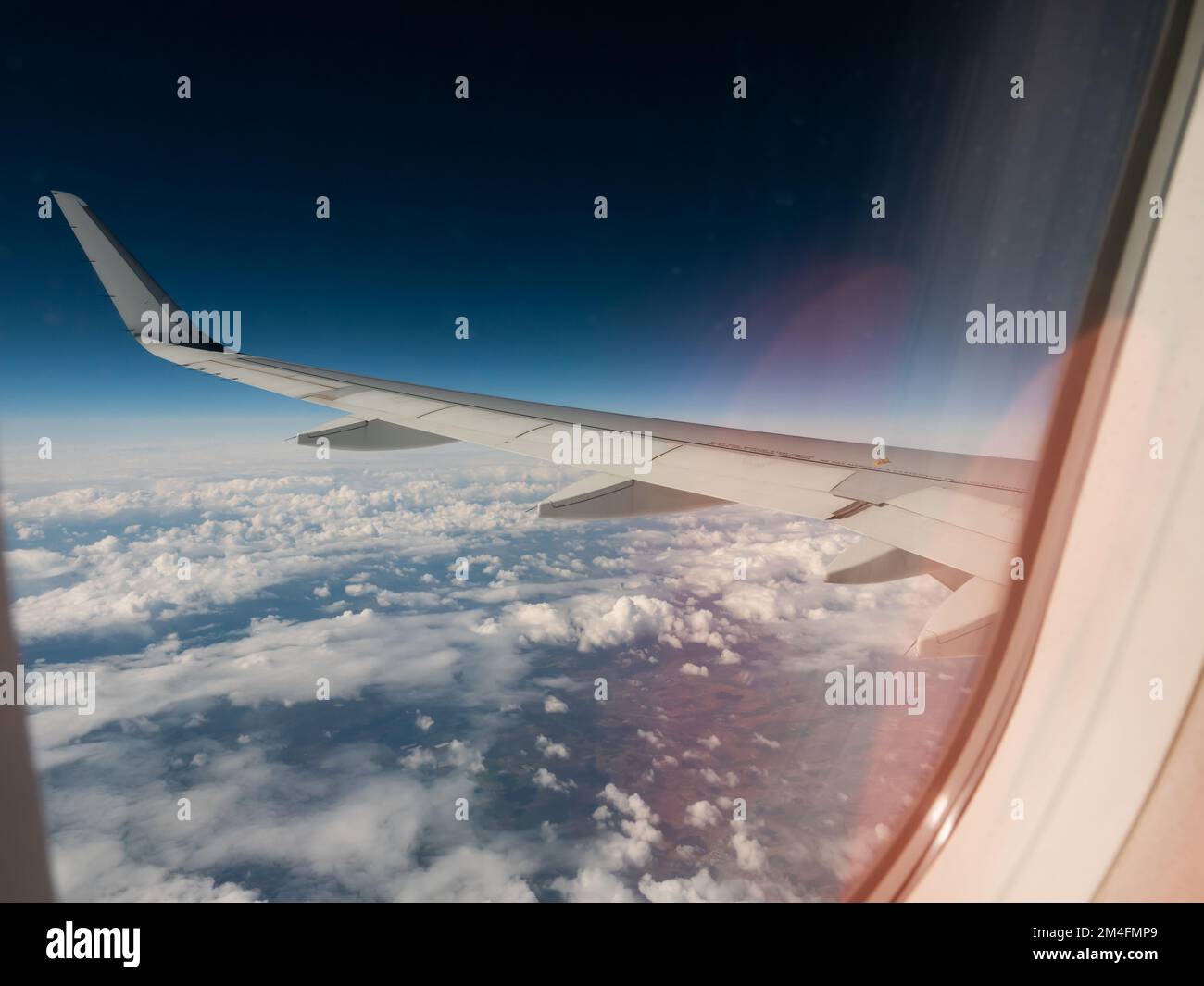 Airplane wing. view from the airplanes porthole Stock Photo - Alamy