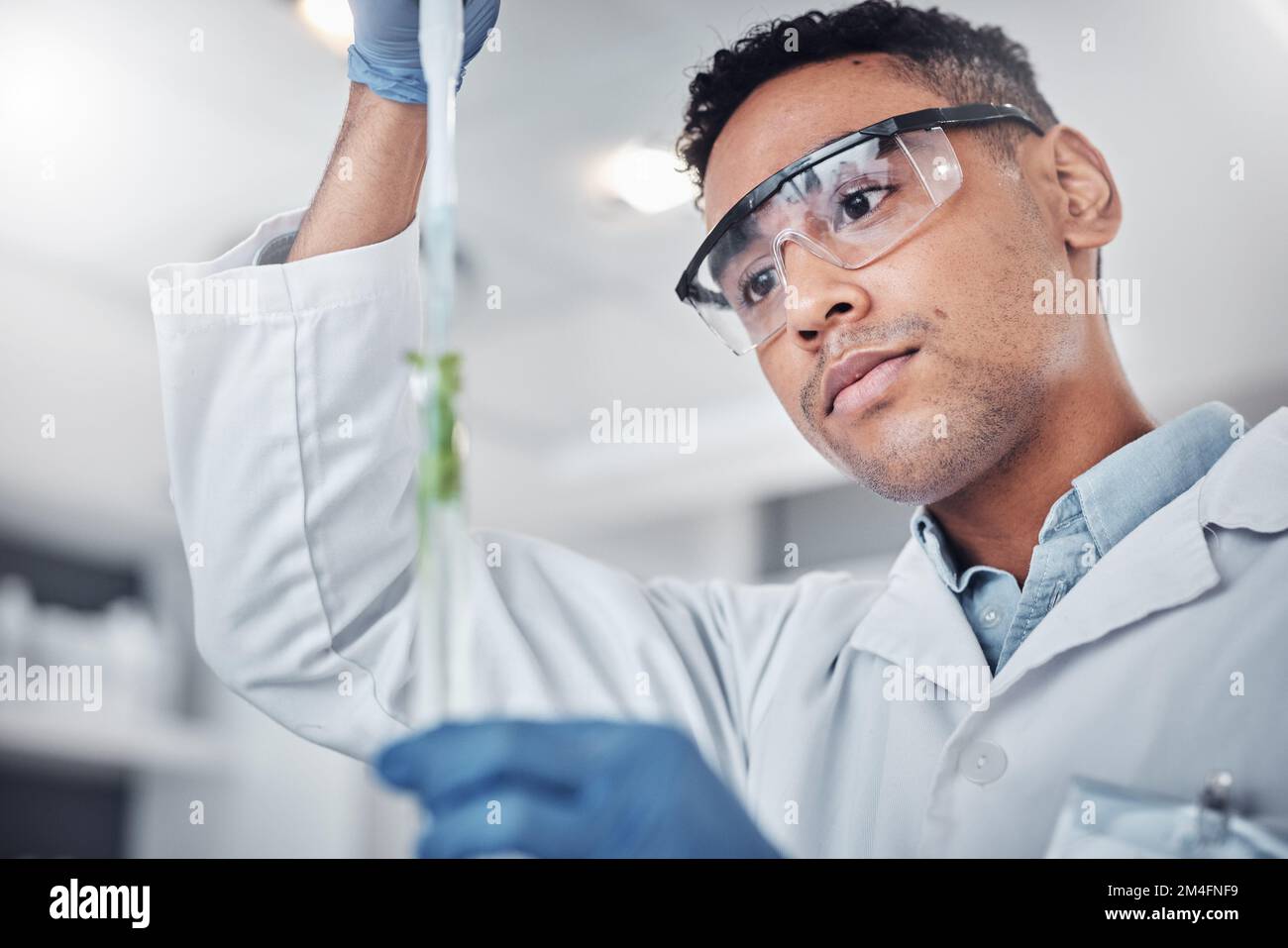 Plant science, pipette and man with test tube for researching plants ...