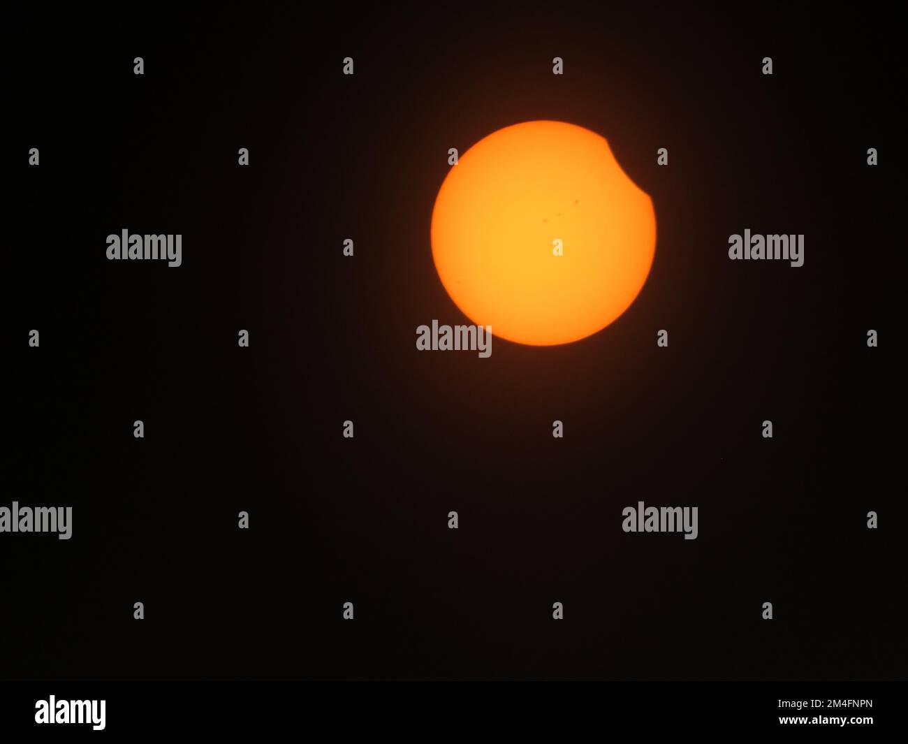 A closeup shot of solar eclipse on black background seen from the Shady Grove Baptist Church