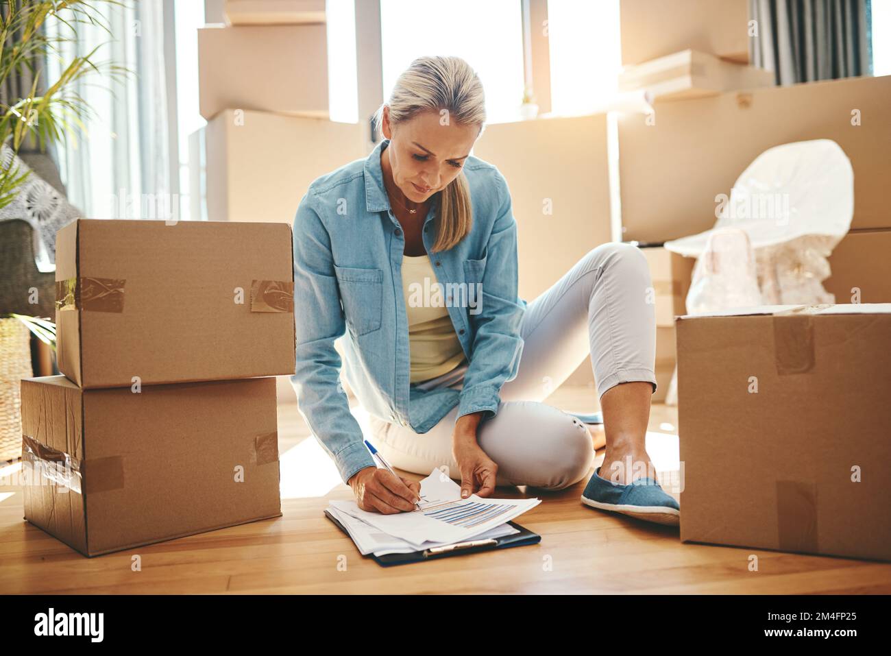 Woman paperwork home mature hi-res stock photography and images - Alamy