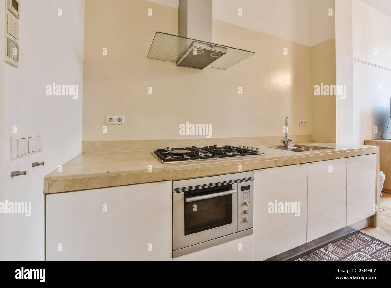 a kitchen with an oven, sink and dishwasher on the counter in this photo is taken from above Stock Photo