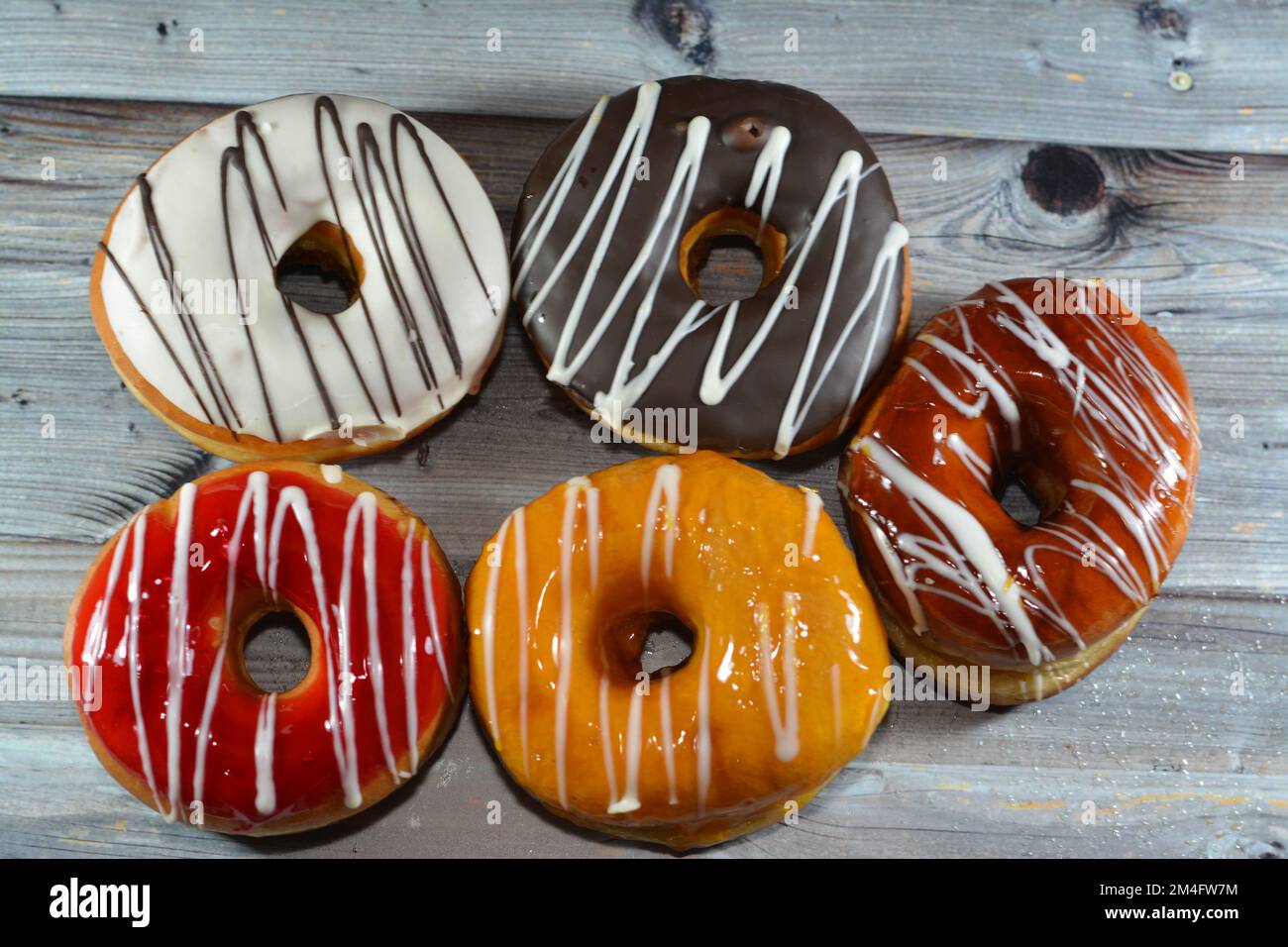 Ring donuts with brown and white chocolate and caramel, strawberry and ...