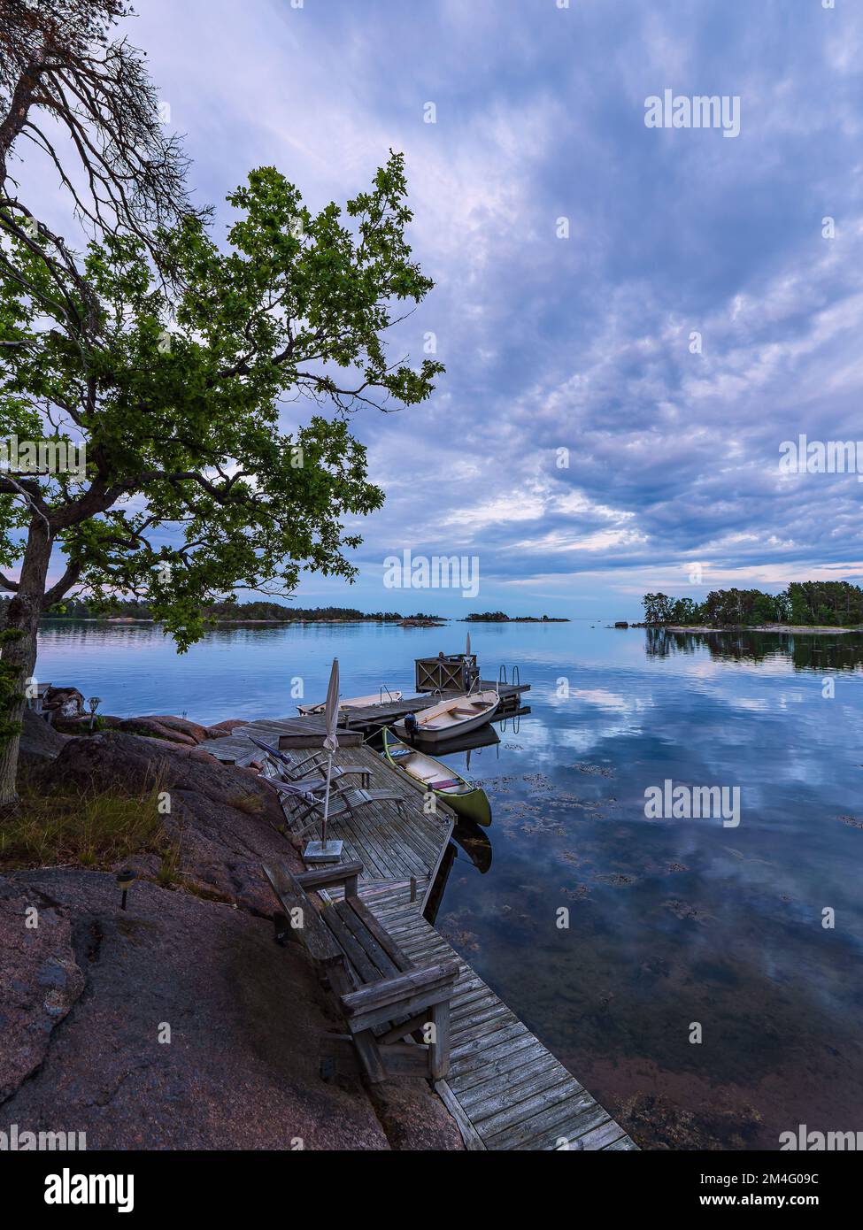 Baltic Sea coast with landing stage and boats near Oskarshamn in Sweden. Stock Photo