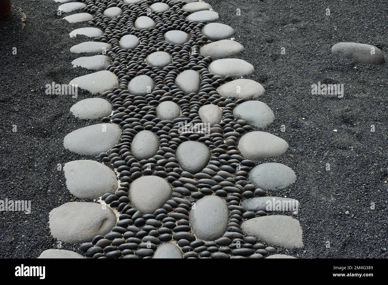 Cobbled path made with volcanic rocks in the Castillo de San Gabriel de Lanzarote Stock Photo