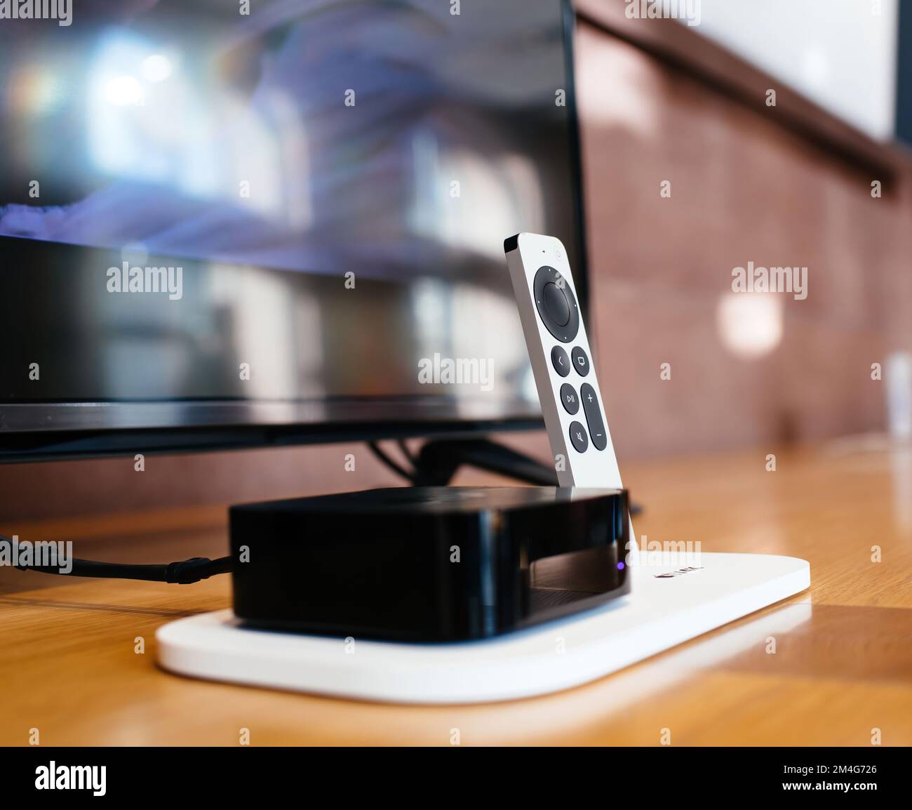 Paris, France - Oct 28, 2022: View of a latest generation Apple TV 4k and its new SIRI remote control. The Apple TV is a digital media player developed by Apple Inc Stock Photo