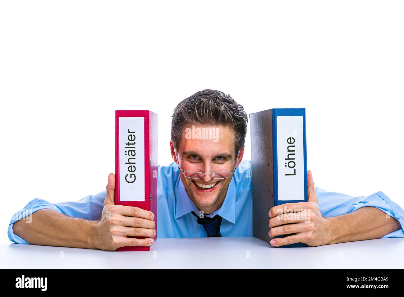 young positive businessman with folders lettering Gehaelter and Loehne, salaries and wages, Germany Stock Photo