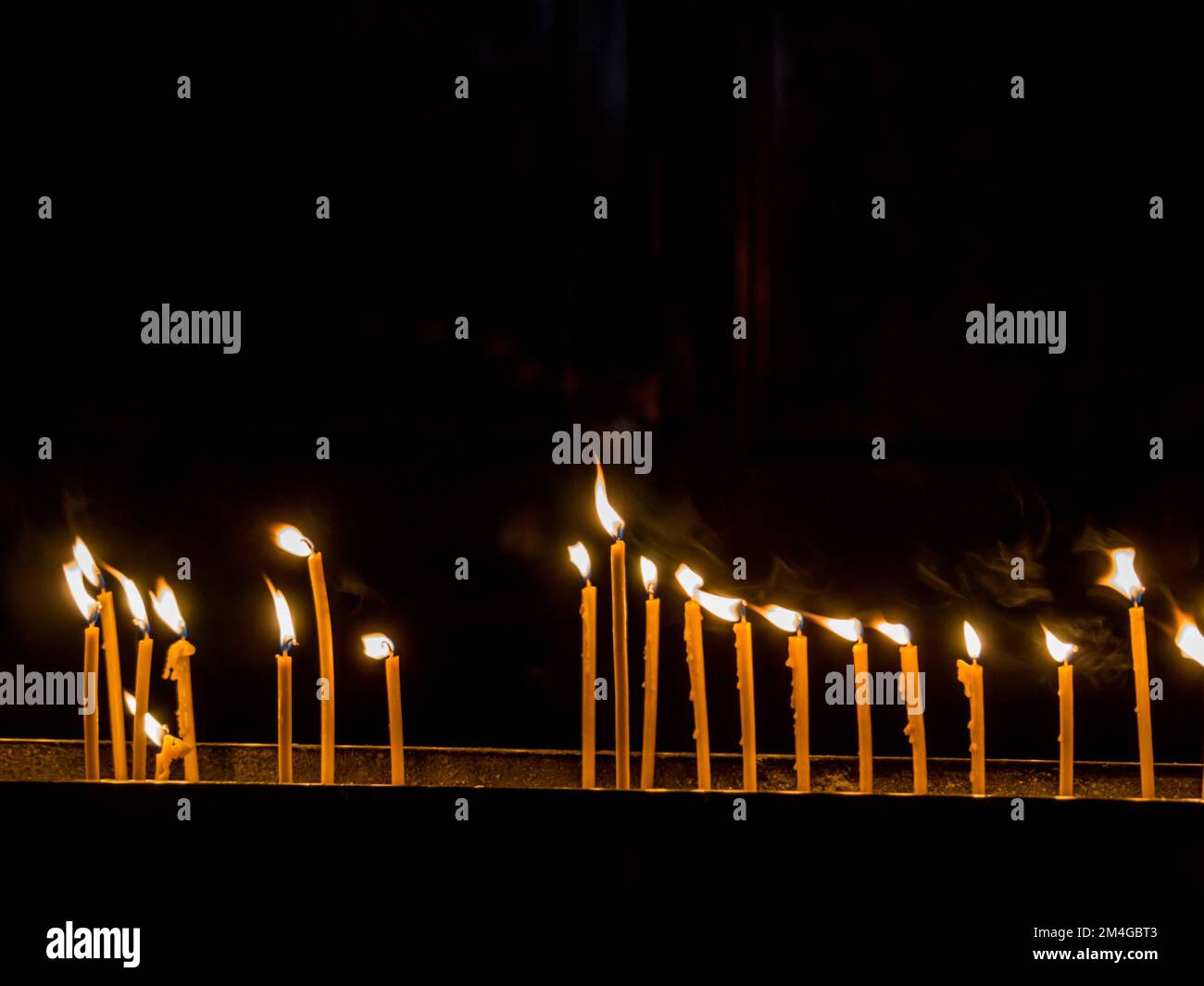 burning candles in a church Stock Photo