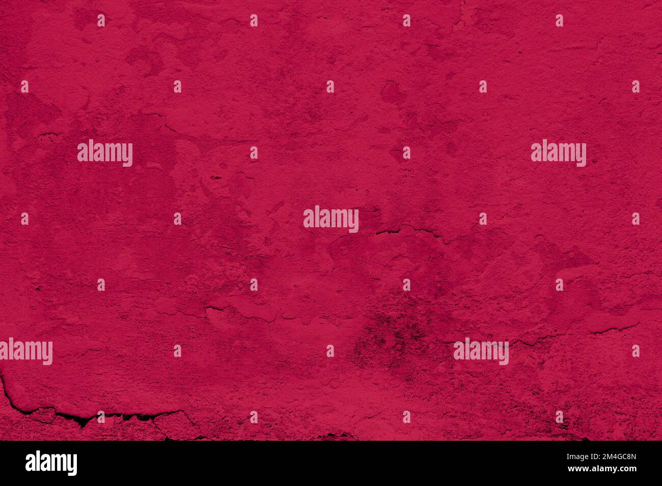 Viva Magenta color of the year 2023. Grunge wall background toned of trendy crimson red color. Copy space. Stock Photo