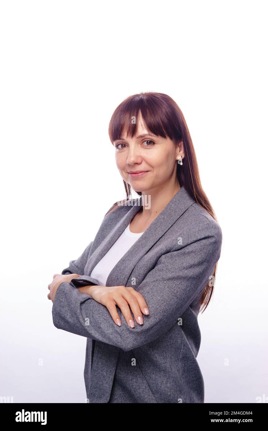 A brunette in a gray suit on a white background. Female business portrait Stock Photo