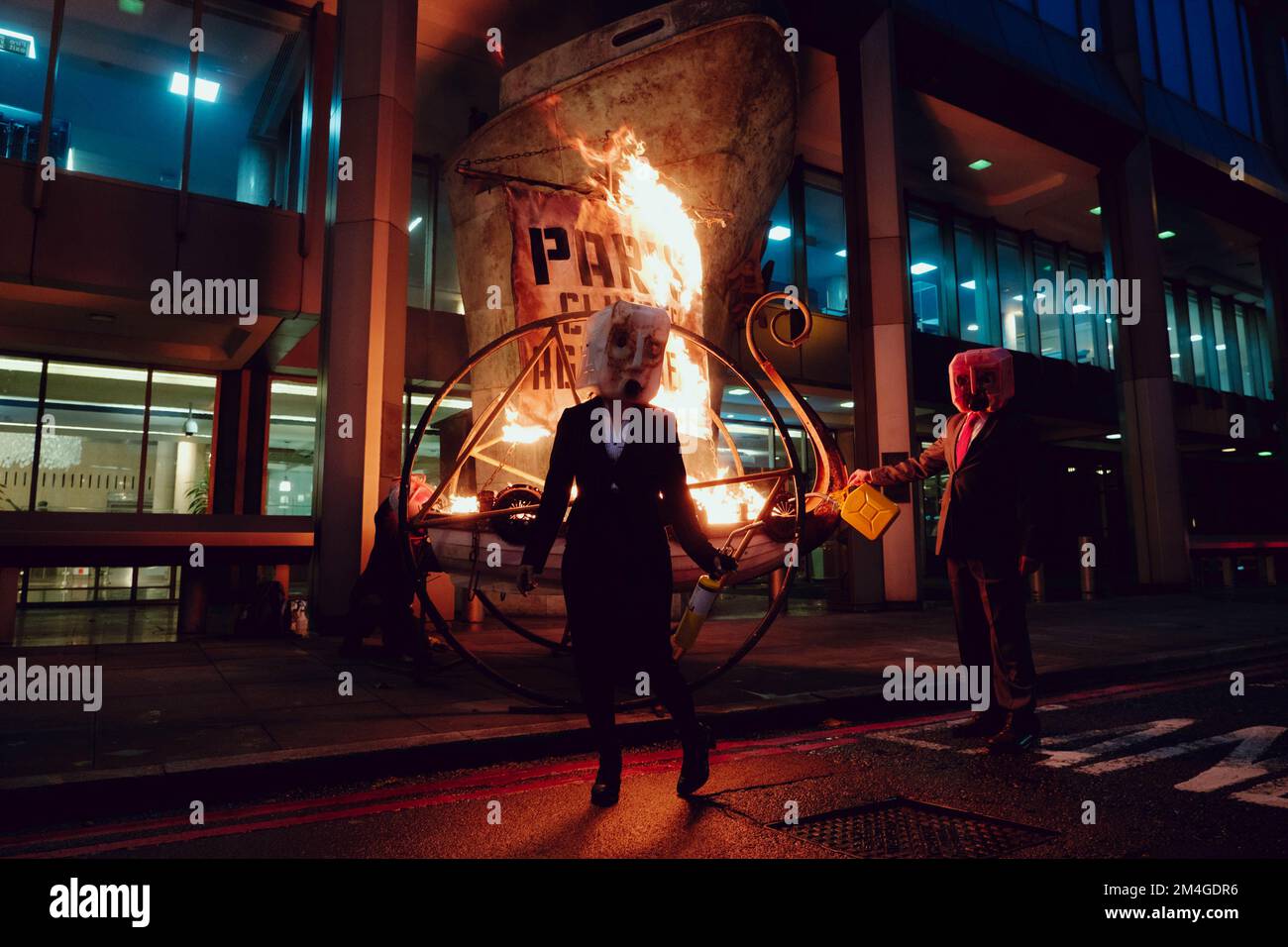 London, UK. 15th November, 2020. Members of Ocean Rebellion, perform an action at the London Headquarters of the International Maritime Organization (IMO) igniting a viking funeral pyre on the sidewalk outside the UN agency’s London headquarters to highlight the backtracking of the global shipping industry against the Paris Climate Agreement. Stock Photo