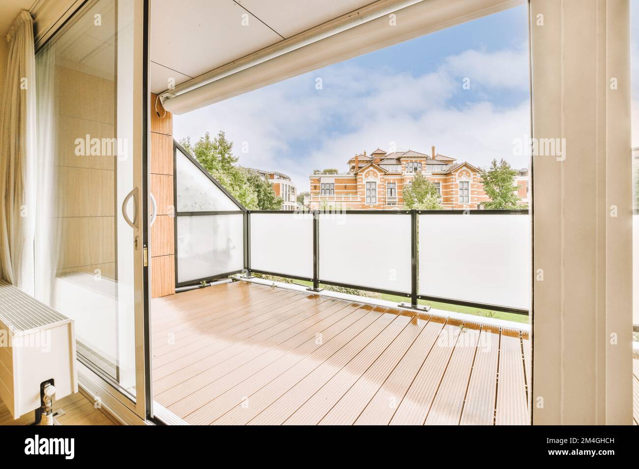 an outside area with wood flooring and sliding glass door that opens to