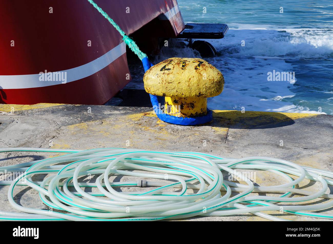Old mooring bollard in a harbour in Greece Stock Photo
