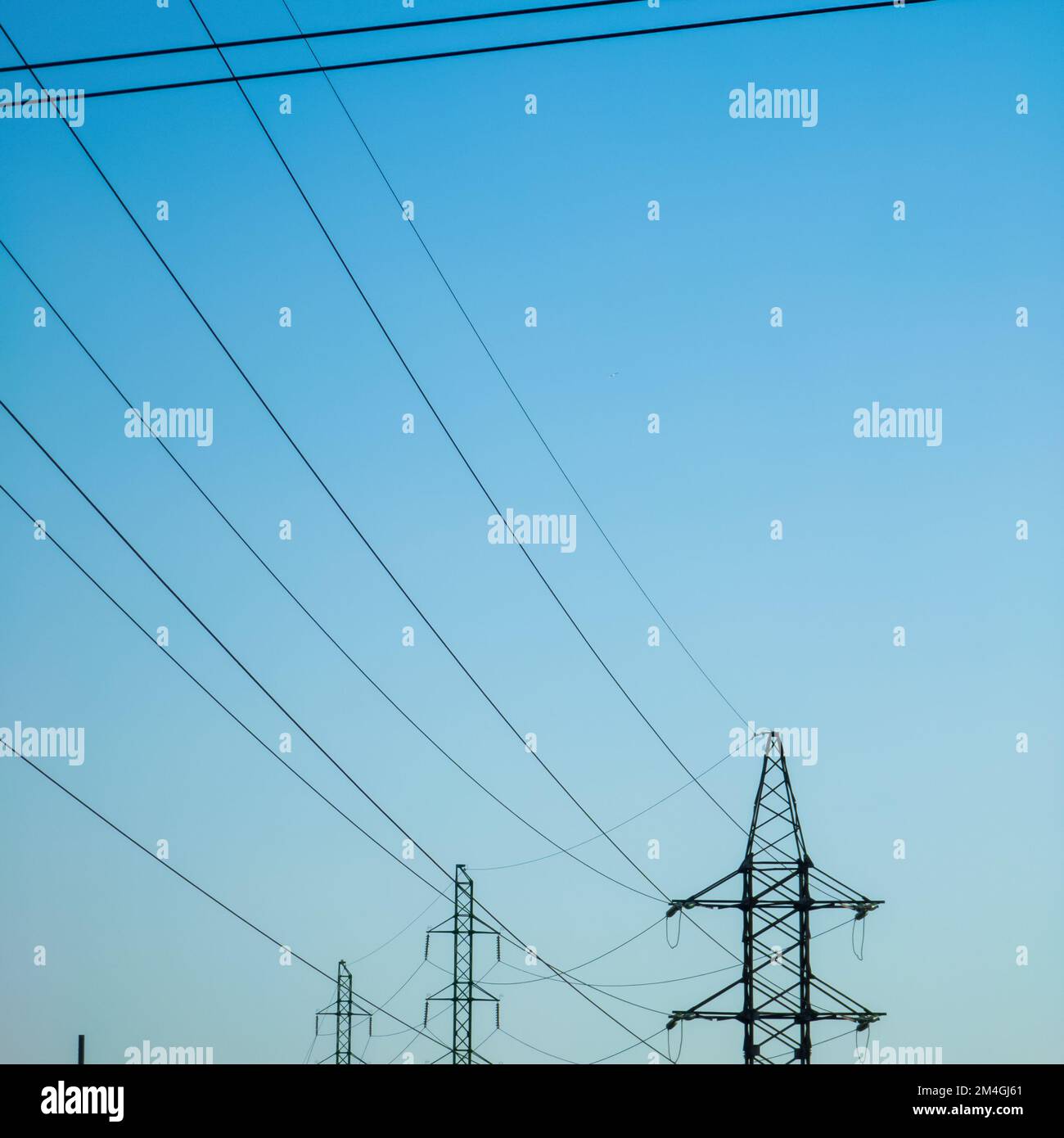 High voltage electricity power line towers against the sky Stock Photo ...