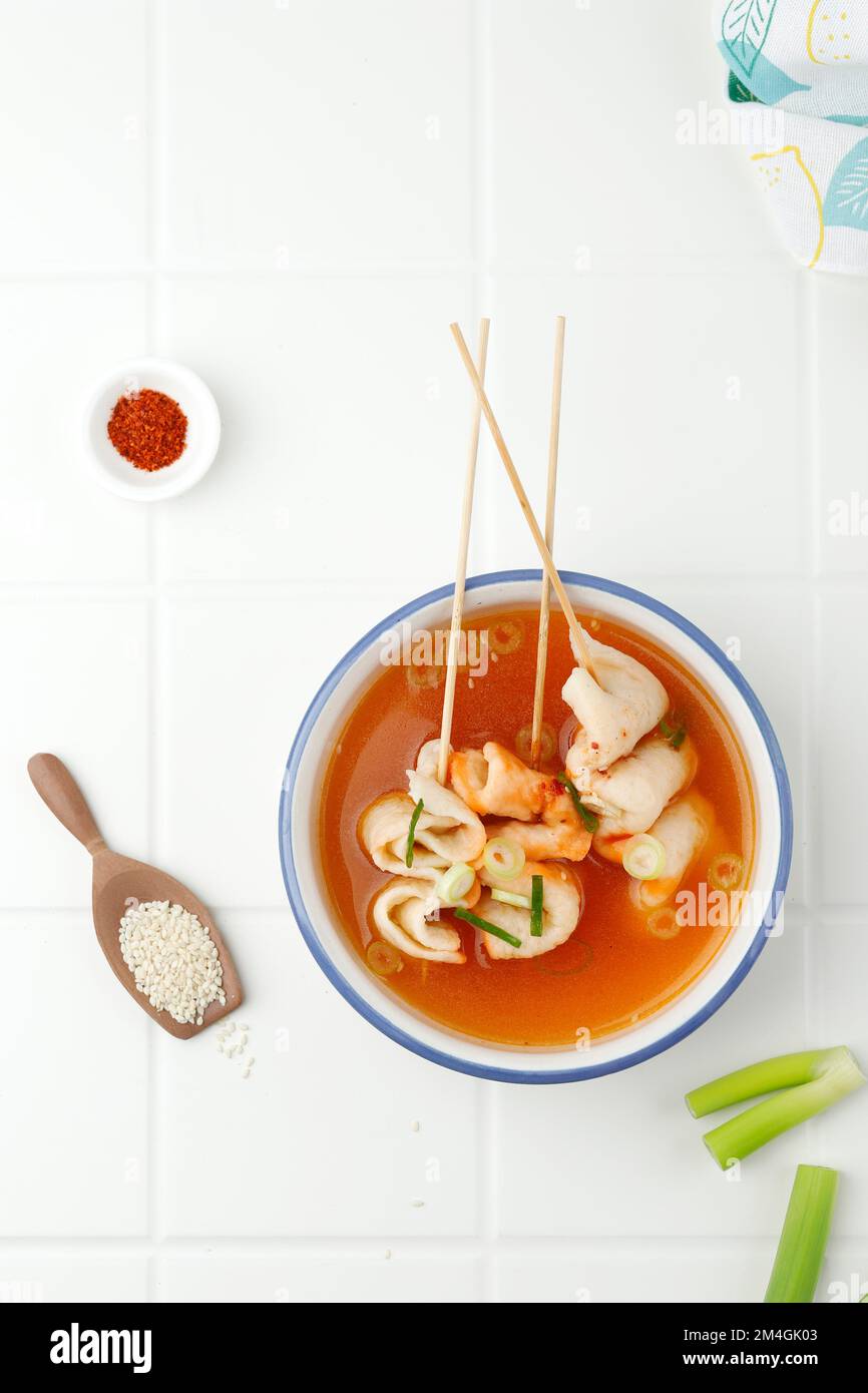 Eomukguk or Odeng Soup, Korean Popular Street Food Made from Fish Cake Eomuk and Spicy Gochujang Paste. On White Table, Top View Stock Photo