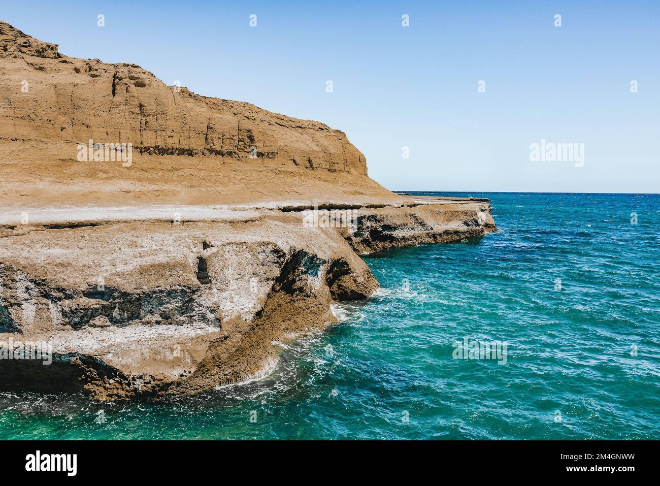 Beautiful landscape of rocky cliff and blue sea in the atlantic coast of Peninsula Valdes, a nature reserve in the Patagonian coast of Argentina. Stock Photo