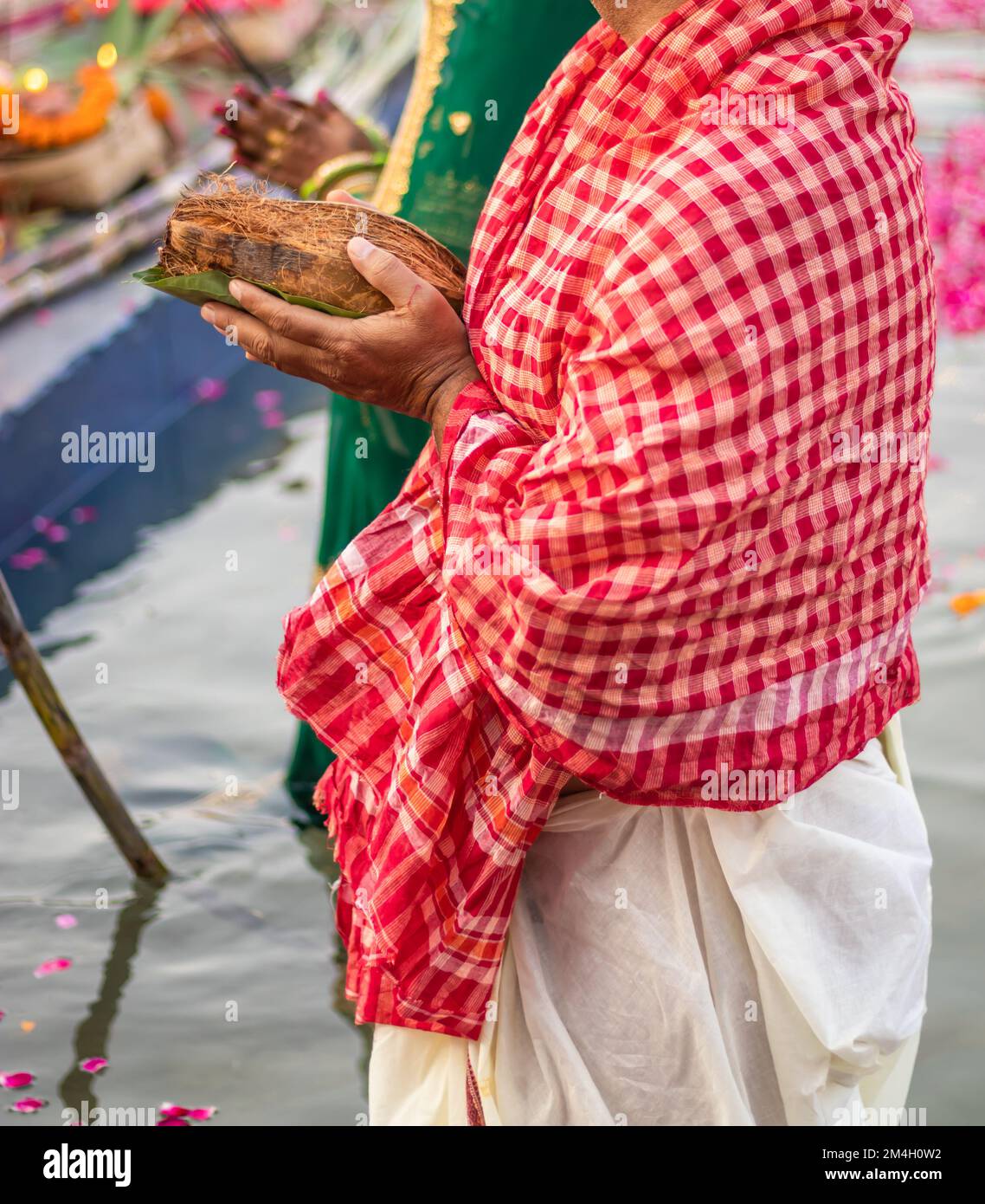 man devotee with religious offerings for sun god during Chhath festival ...