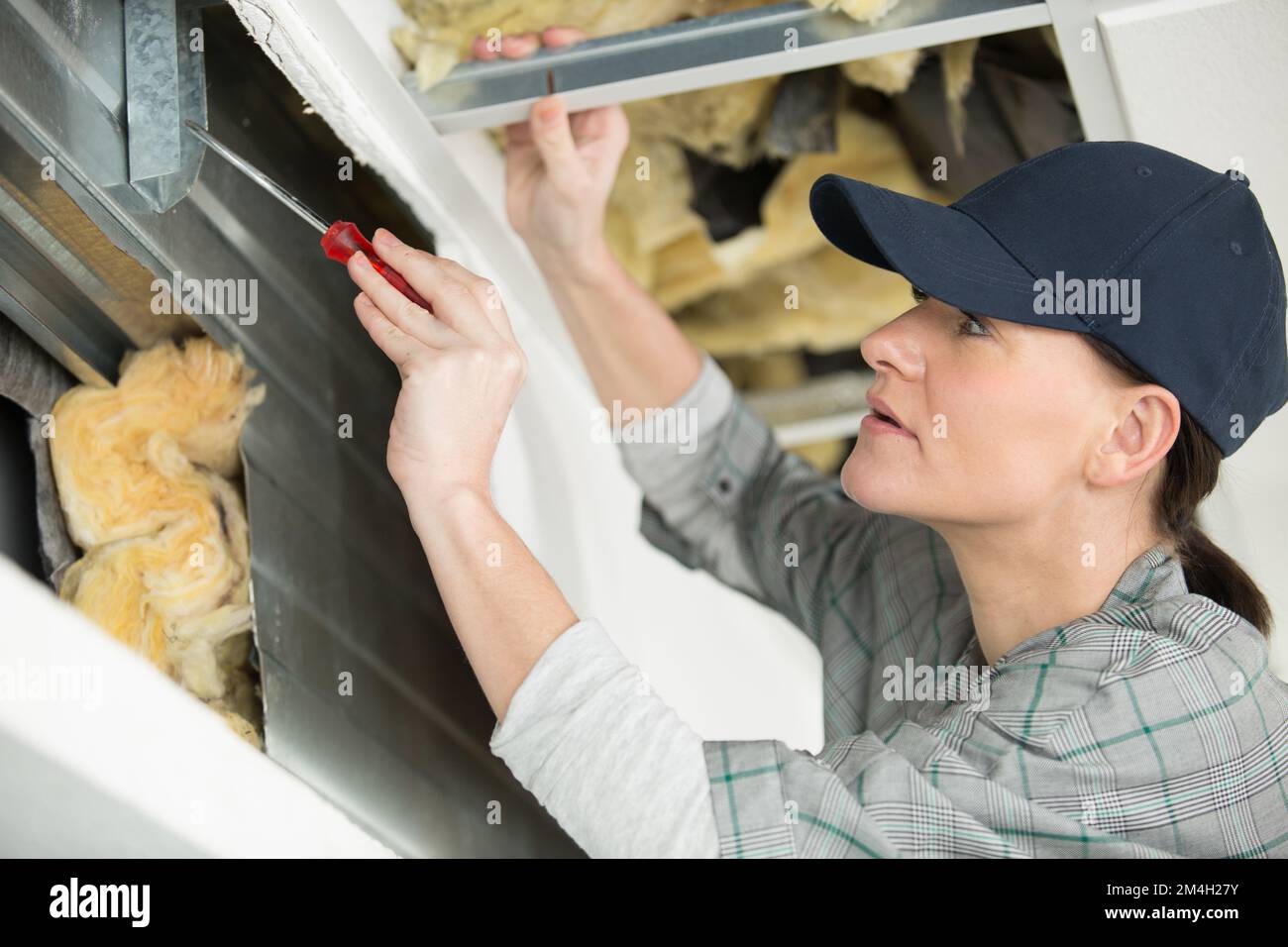 Shutterhand Worker woman working on roller shutter cavity Stock Photo - Alamy