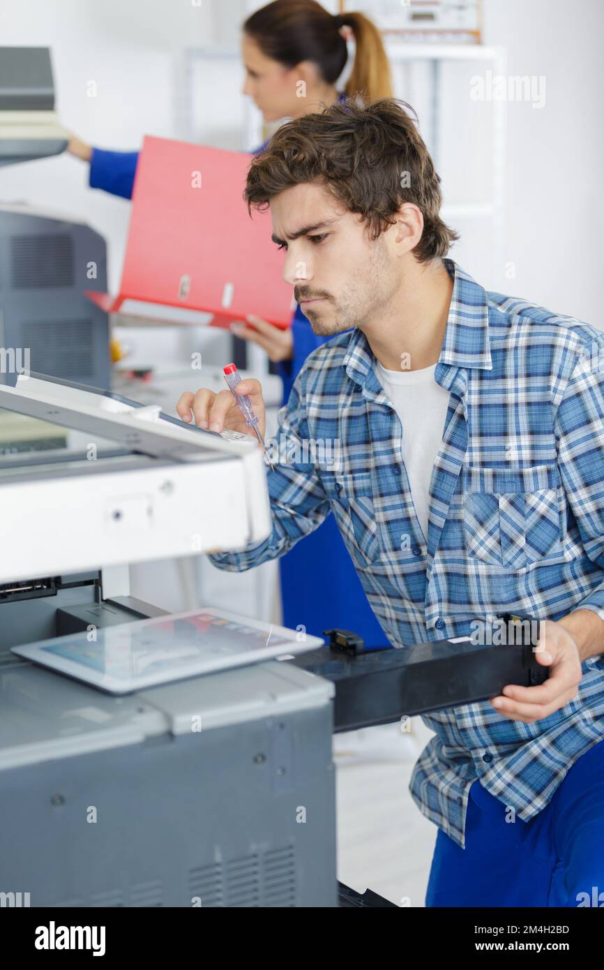 technician man opening photocopy machine in a office Stock Photo - Alamy