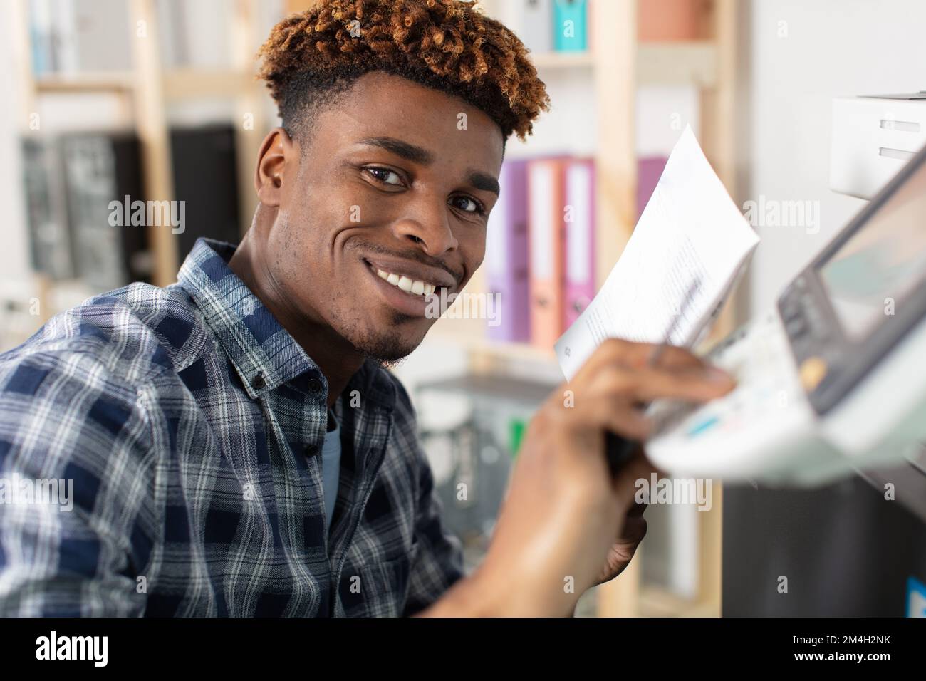 man reading instruction for 3d printer Stock Photo