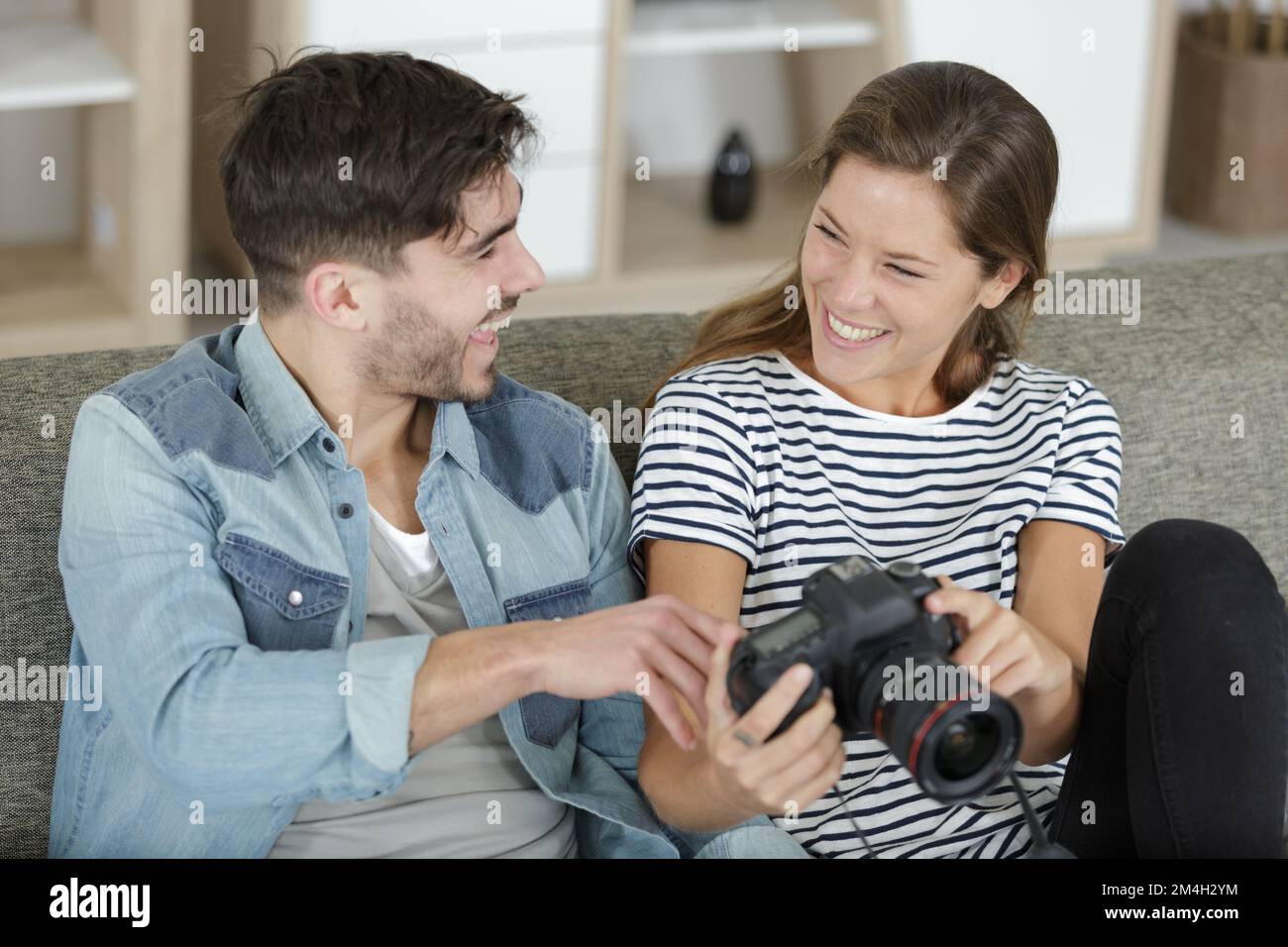 happy embraced couple looking at travel picture Stock Photo - Alamy