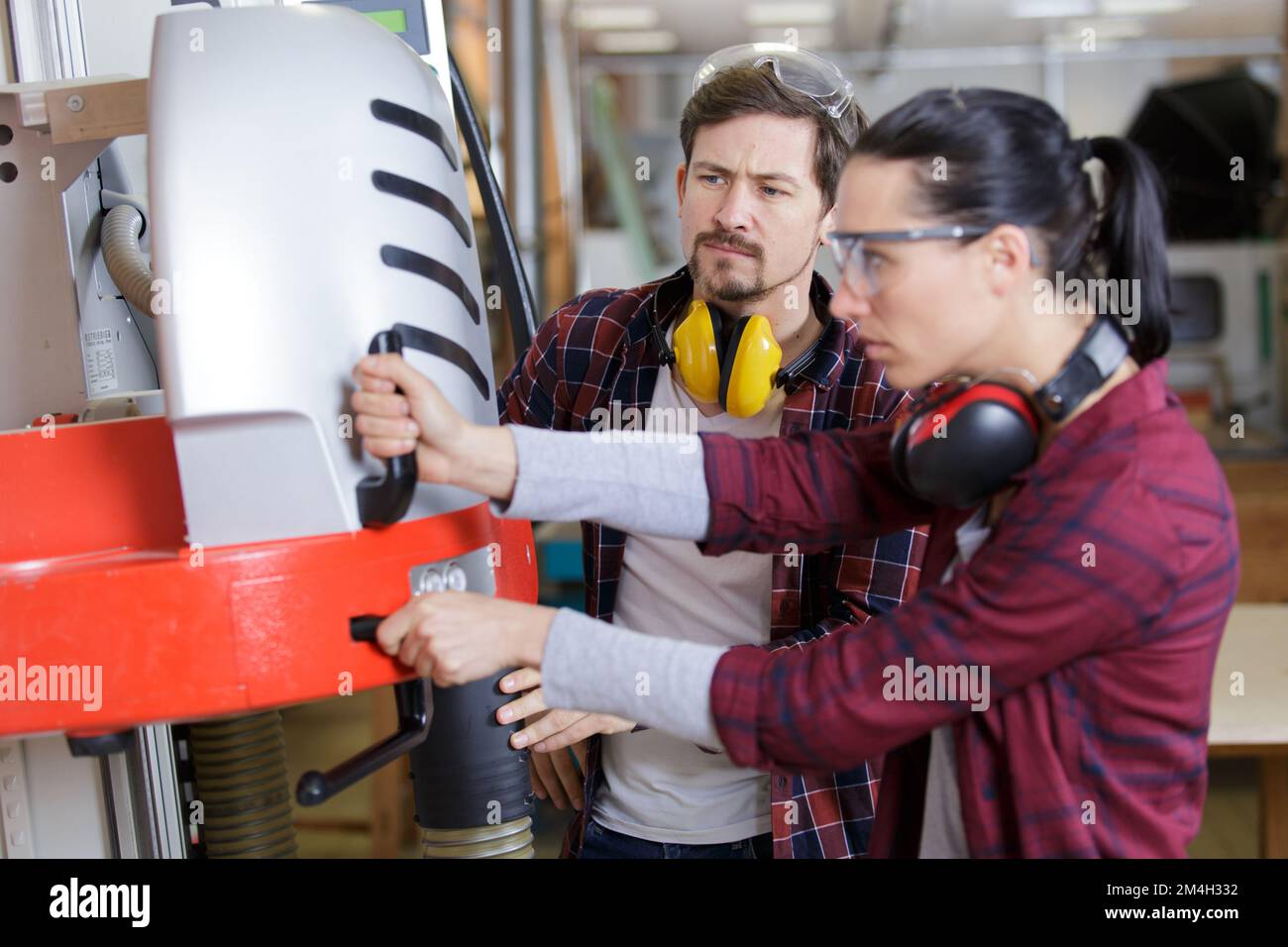 man and woman with machine cnc in factory Stock Photo - Alamy